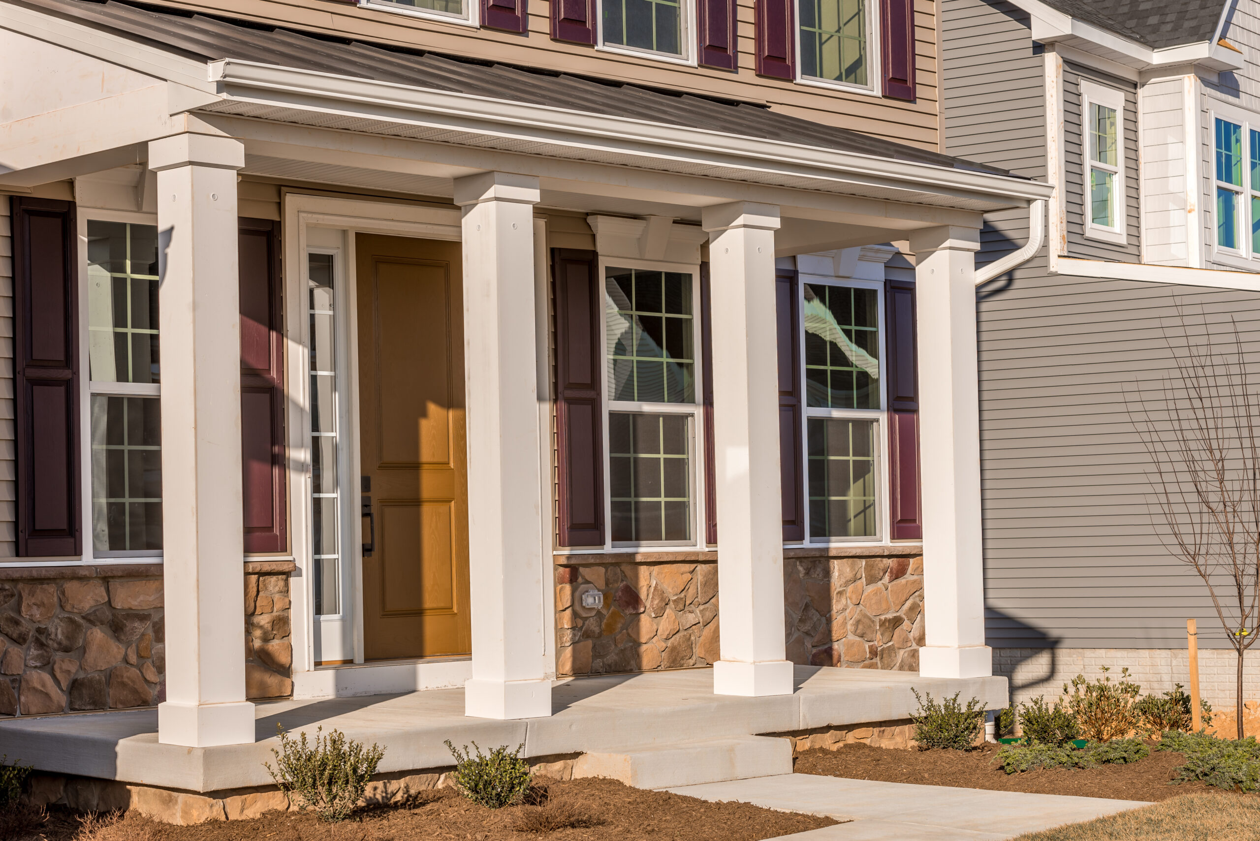 Colonial White Porch Post Columns Using Wood Looking Low Maintenance Vinyl Column Wraps on a House